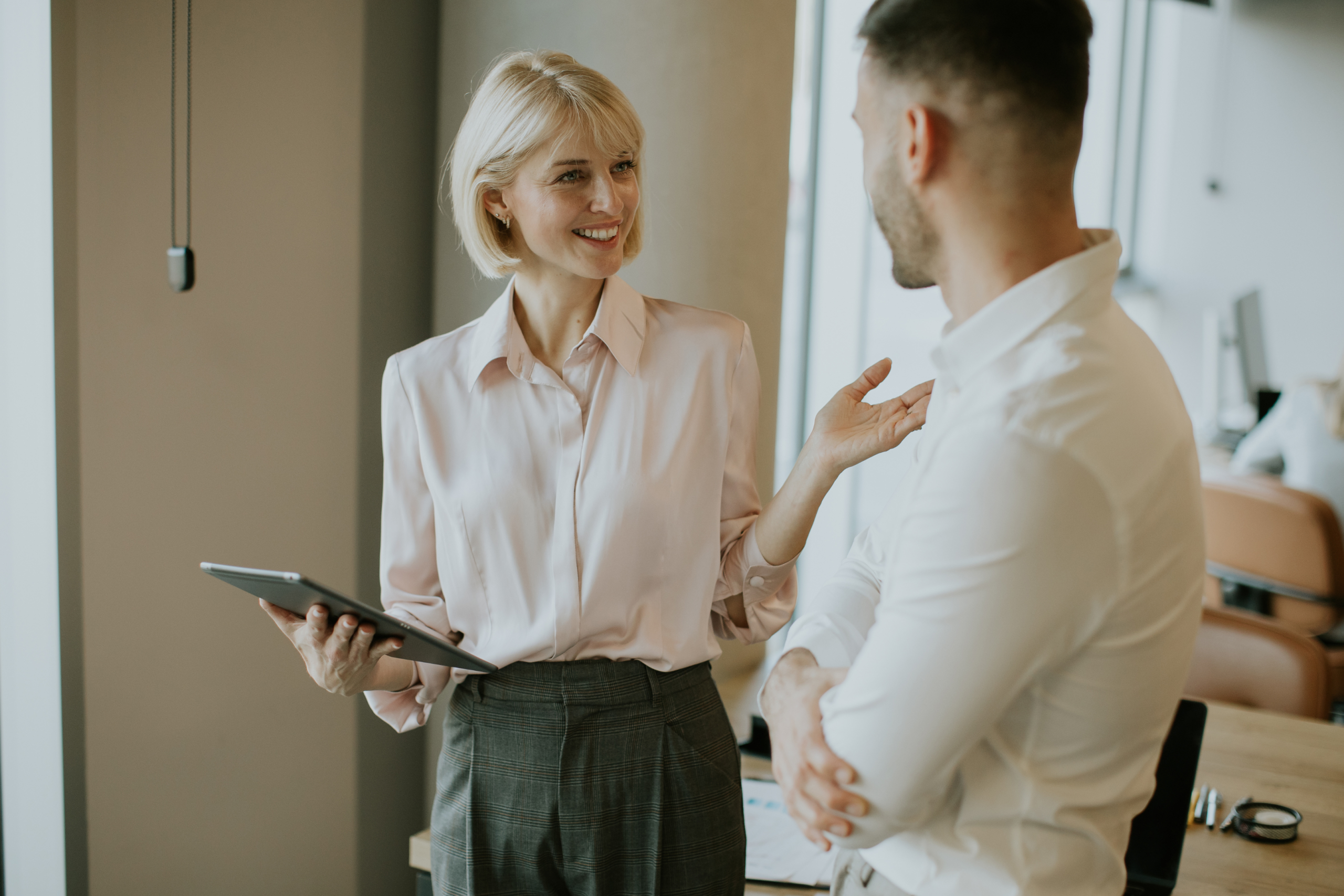 Employee speaking with HR manager about workplace concern in a professional office setting
