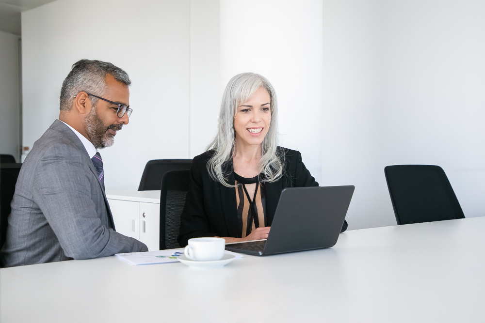 Two professionals reviewing work together